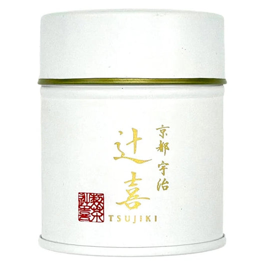 A white cylindrical metal tea canister with a gold band around the middle, featuring gold and red Japanese characters and the brand name TSUJIKI on the front, set against a plain white background.